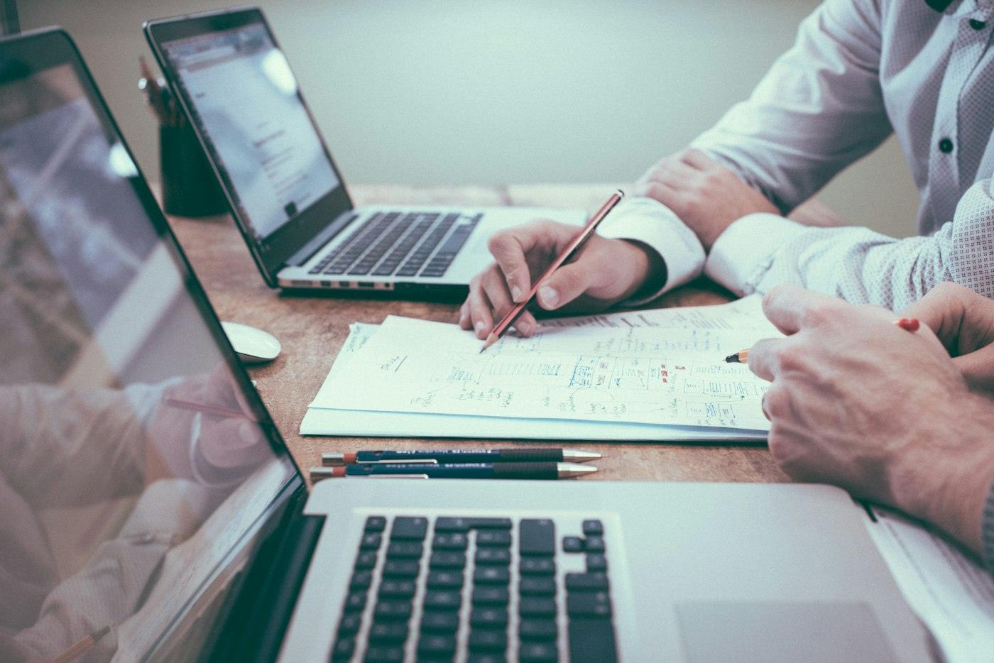 Two people reviewing paperwork at a desk