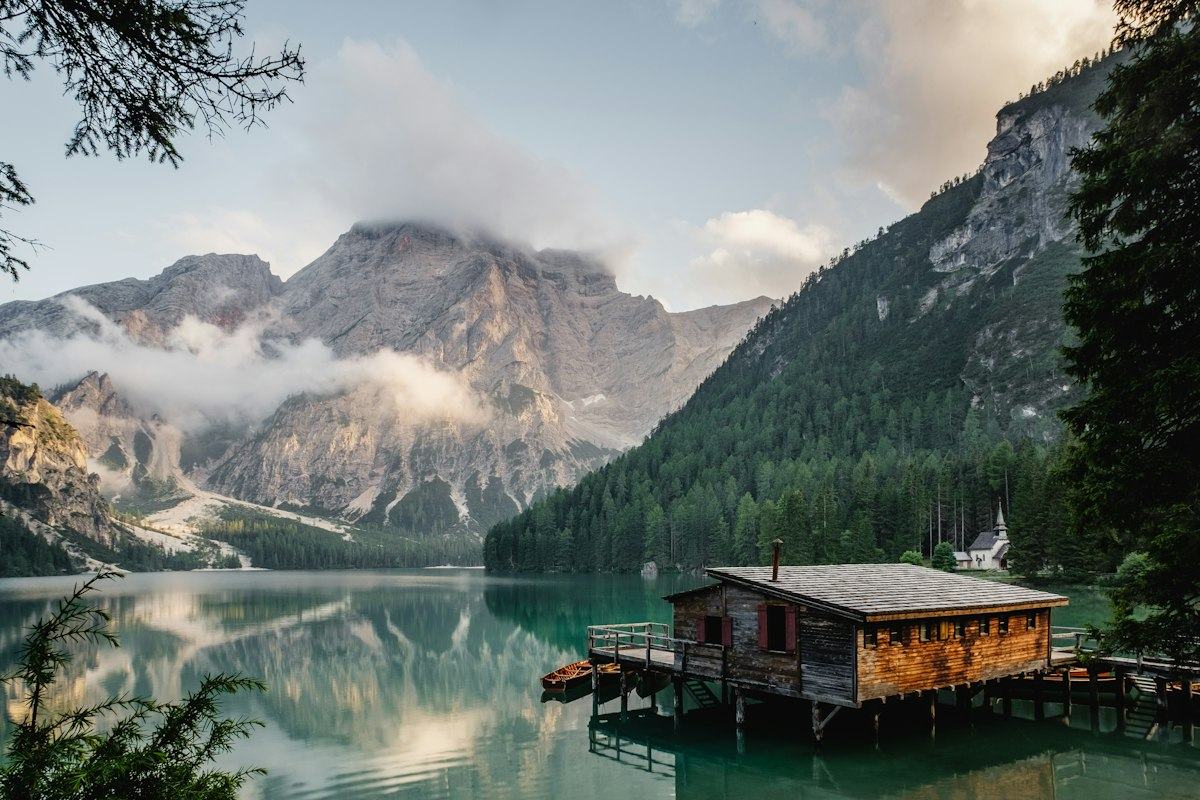 Lakeside cabin beneath mountains